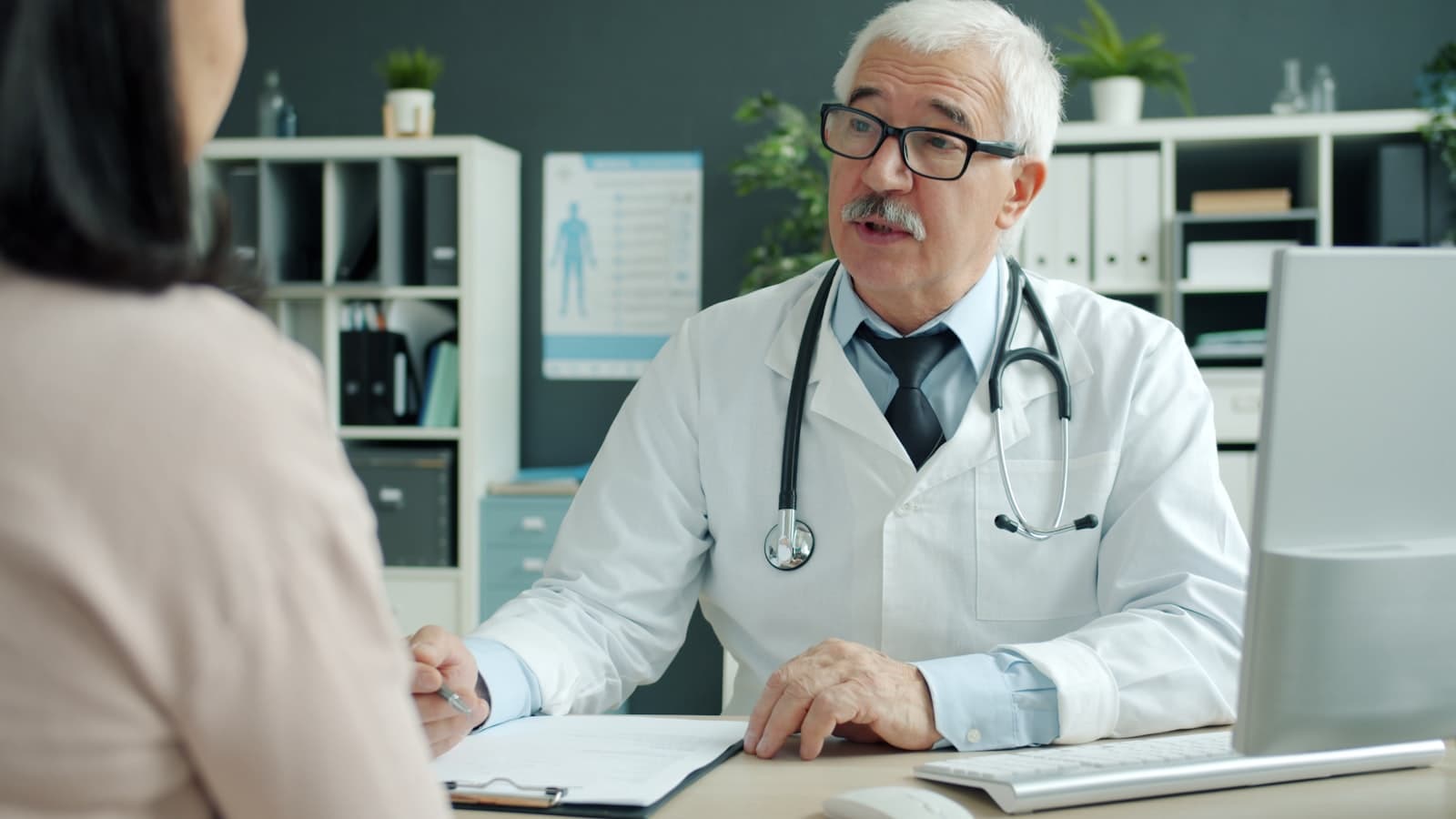 A senior Careline physician in consultation with a patient