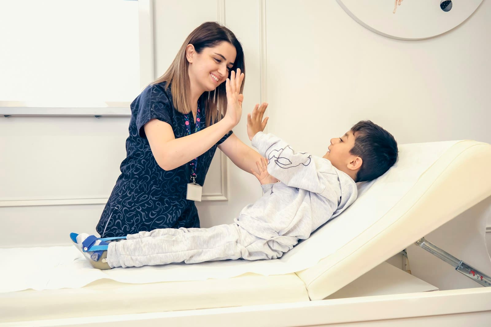 A Careline nurse and a young patient sharing a high-five